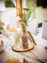 Details of a rustic wedding table with camomiles