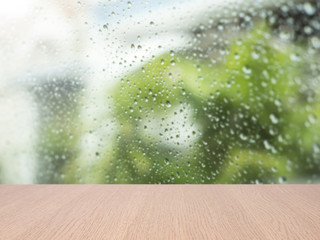 top empty wood table on blurred abstract water drop on glass background. can be used for display or montage your product.