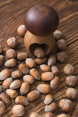 .hazelnuts and nutcracker on a wooden background