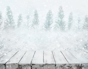 White wood table top on blurred snowfall in winter season