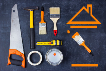 Work tools for repair of home on black surface.