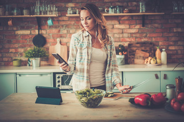 Woman listening music while cooking