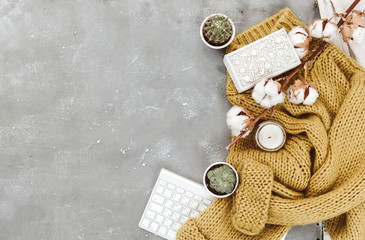 Flat lay composition with warm sweater, keyboard and cotton. Blogger concept, cozy background with copy space