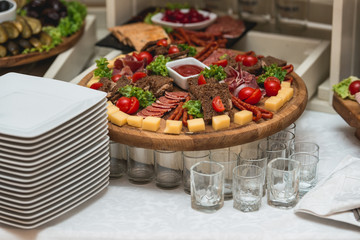 Mix cheese on wooden board with meat and bread