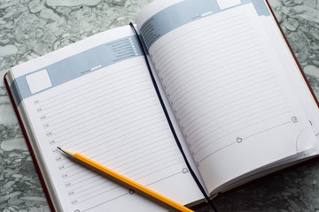 Business and study instruments on desktop. Notebook, highlighter and pencil.