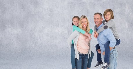 Family giving piggybacks and grey background