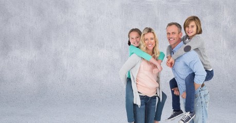 Obraz premium Family giving piggybacks and grey background