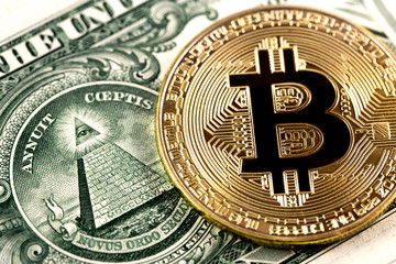 Fototapeta na wymiar bitcoin coin on one dollar