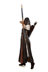 full length portrait of girl wearing brown  fantasy costume, holding a bow and arrow, on white...