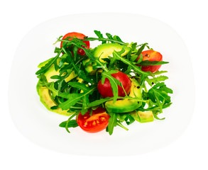 Vitamin vegetarian salad from arugula and avocado on white plate
