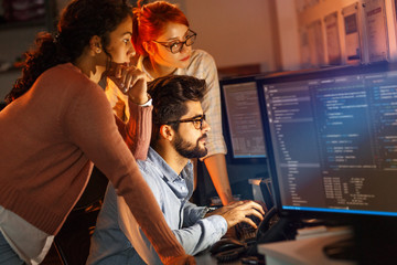 Team of  programmers working on new project.They working late at night at the office.