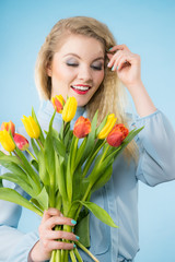 Pretty woman with red yellow tulips bunch