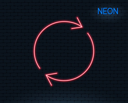 Neon light. Refresh line icon. Rotation arrow sign. Reset or Reload symbol. Glowing graphic design. Brick wall. Vector
