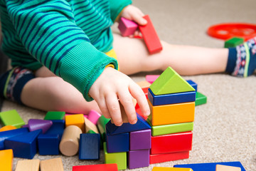 Child playing with building blocks learning new skills