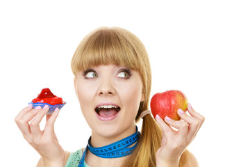 Woman choosing fruit or cake make dietary choice