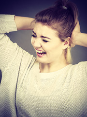 Unhappy woman screaming and yelling in pain
