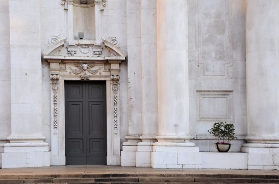 Church parvis with secondary entrance gate. New Cathedral Brescia, Italy. Baroque architecture.