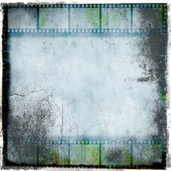 Grunge blue film strip frame with cracks.
