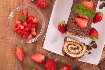 Chocolate roll with hazelnuts and strawberries. 