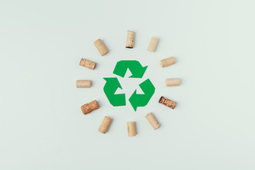 top view of recycle sign and bottle corks around isolated o grey