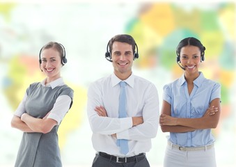 Obraz premium Travel agents wearing headsets in front of world map