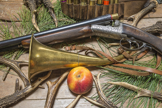 hunting rifle and equipment on old wooden background