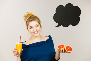 Happy woman holding fresh orange juice