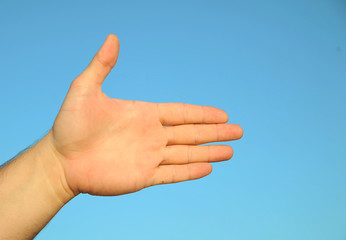 Male hand's on the sky background
