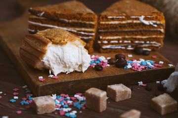 three tender cake with coffee beans and bright powder on a gray wooden background. Selective focus, close up. background for postcard.