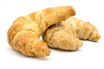 Fresh two croissant isolated on a white background closeup .