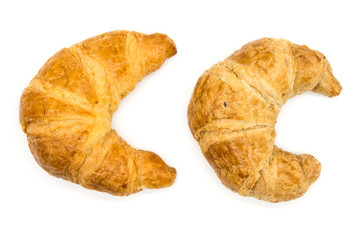 Fresh two croissant isolated on a white background closeup .