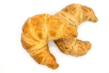 Fresh two croissant isolated on a white background closeup .