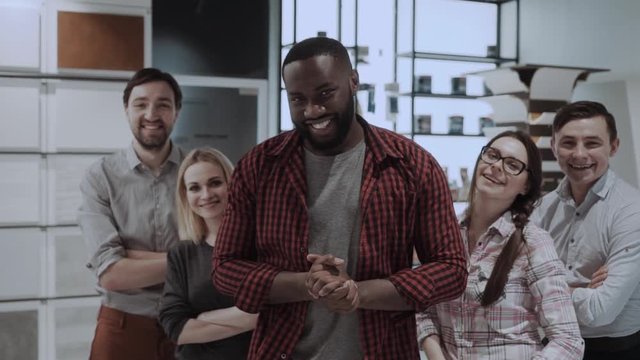 Smiling multi ethnic business team in creative office, casual clothing. Design studio