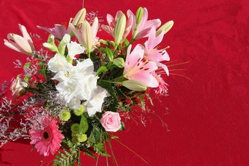 Buket of white and pink flowers on digitally filtered red background