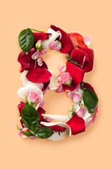 Letter B made from red roses and petals isolated on a white background