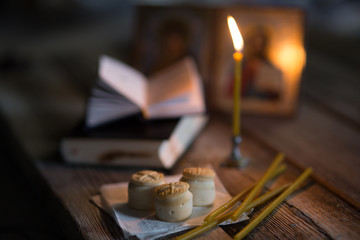 andle against the background of orthodox icons