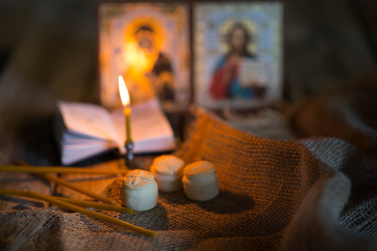 andle against the background of orthodox icons