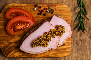 Sandwich with smoked meat and mustard