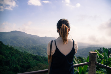 Naklejka premium Women looking to mountain in morning travel concept.