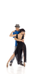 Two sexy young artists couple dancing close in studio, on pointe, white background
