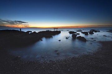trii - gateway of shrine in the sea in the early morning by long exposure