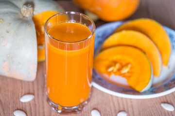 Pumpkin juice in glass with pieces of pumpkin