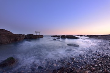 trii - gateway of shrine in the sea in the early evening by long exposure