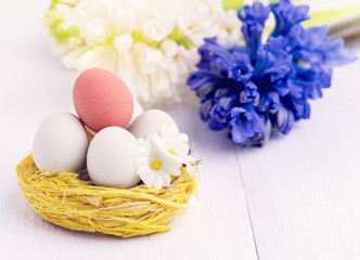 Obraz na płótnie Canvas Spring Flowers with Easter Eggs in Nest Easter Spring Background with Hyacinth White Copy Space Easter Concept