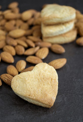 Homemade cookies with almonds on a dark background.