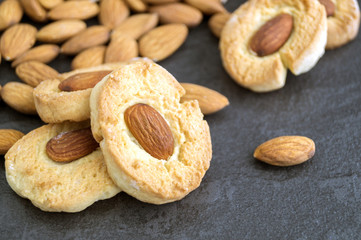 Homemade cookies with almonds on a dark background.