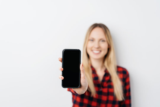 Woman Holding Out A Mobile Phone With Blank Screen