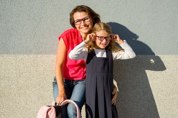 Portrait of a Mom and Daughter of a Small Schoolgirl with Glasse