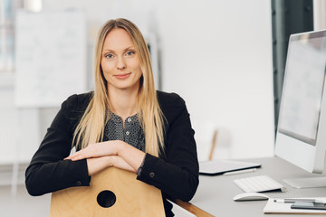 Businesswoman looking over the back of her chair