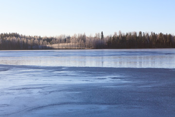 Fototapeta na wymiar Cold morning winter lake scape in Finland